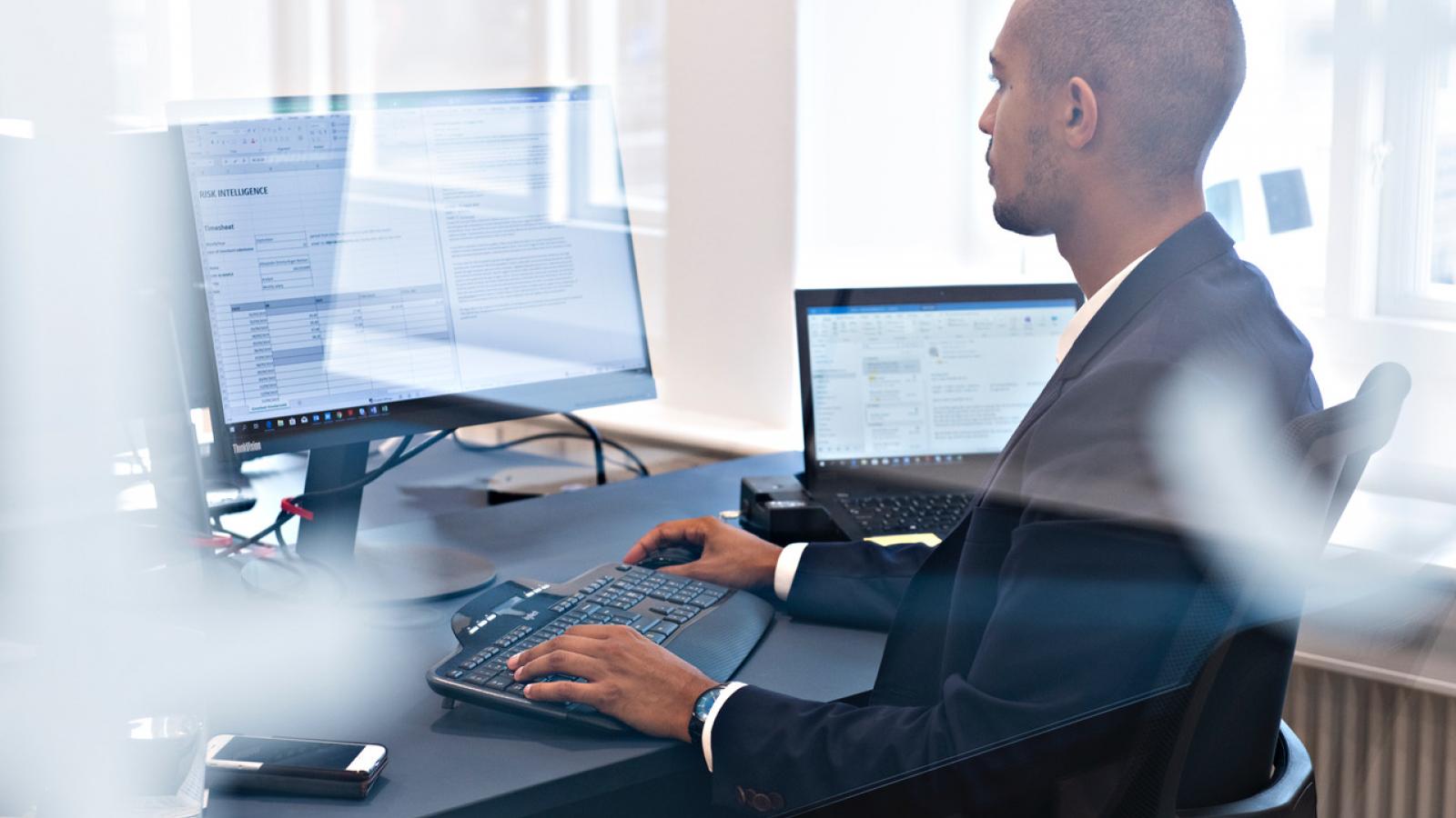 Risk Intelligence consultant working on client project at his desk