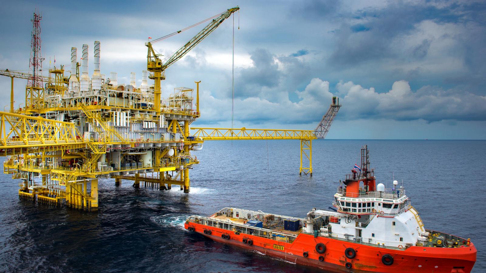 Supply vessel by offshore oil rig